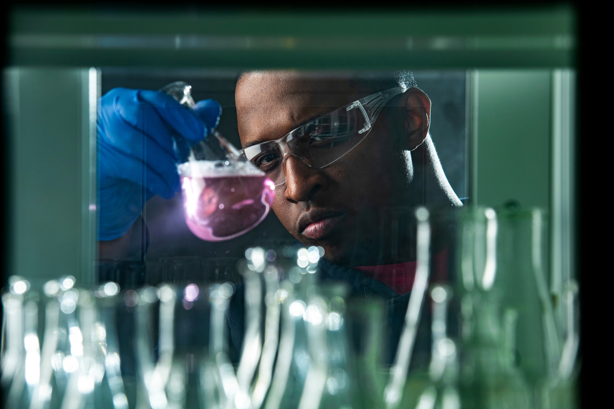 A student examines a beaker in Kielhorn lab